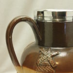 Doulton Lambeth stoneware jug with sterling silver mount