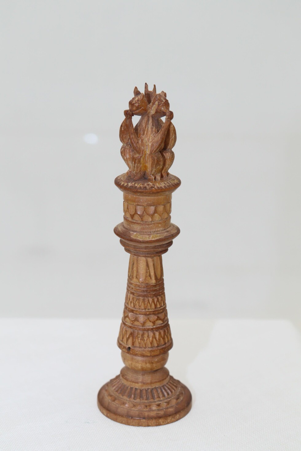 Carved wooden needle holder