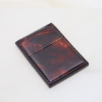 Celluloid card case with X swivel action